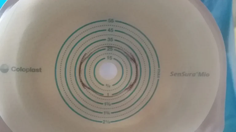 An ostomy barrier with a hand‑drawn marker line showing where the opening should be cut.