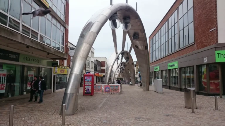 Modern lighting arches with spherical lamps on a city shopping street