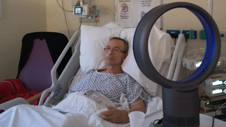 The blog author lying in an intensive care unit bed with oxygen support during a period of sepsis.