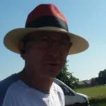 The author of the glog during a late afternoon walk, wearing a colourful hat to shield his face from the sun, during chemotherapy.
