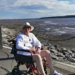 The author in a wheelchair on the road separating Marine Lake from the sea in Weston-super-Mare.