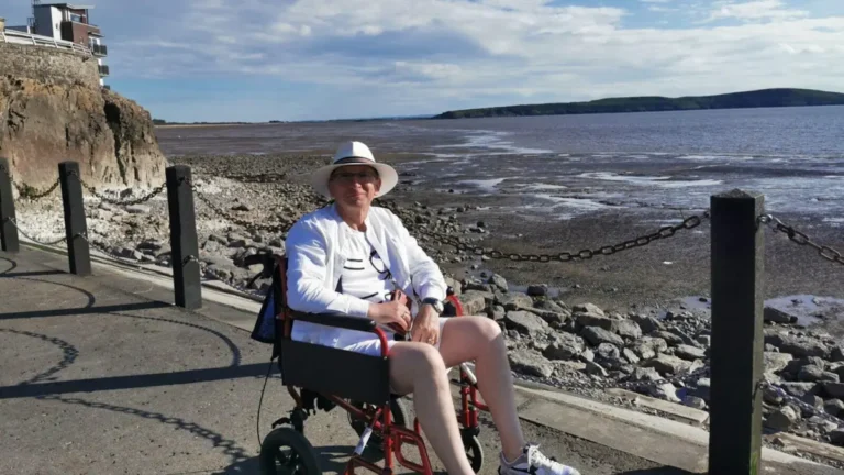 The author in a wheelchair on the road separating Marine Lake from the sea in Weston-super-Mare.