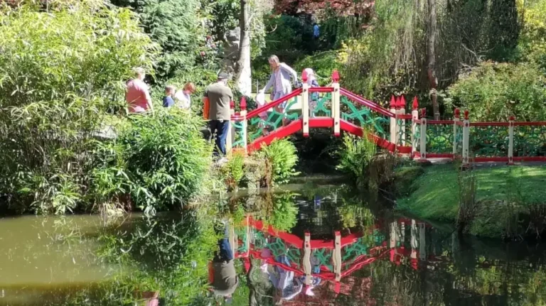 Red, green and white bridge over the pond in the oriental part of Biddulph Grange Garden