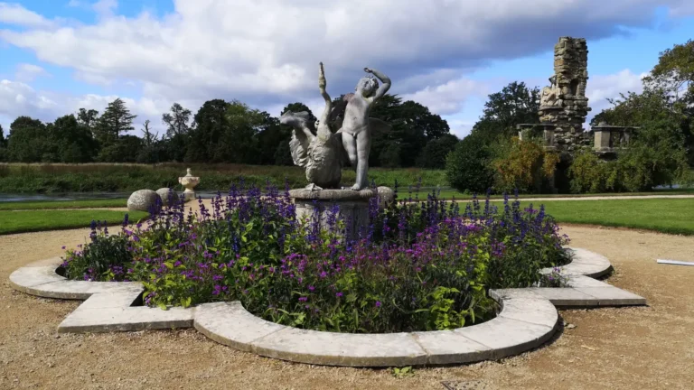 Stone fountain with a lead figure of a boy and a swan at Shugborough Estate.