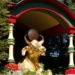 A golden statue of a bull in the garden of Biddulph Grange, holding a ball between its horns, surrounded by plants in the Chinese section of the garden.