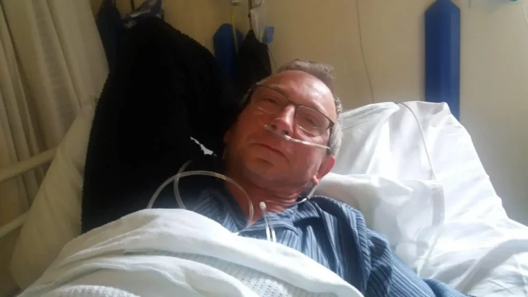 The author of the blog in a hospital bed, weakened, with an oxygen tube in his nose and his eyes half closed.