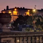 A warmly lit historic building in Weston‑super‑Mare at night, with architectural details glowing against the dusk sky.