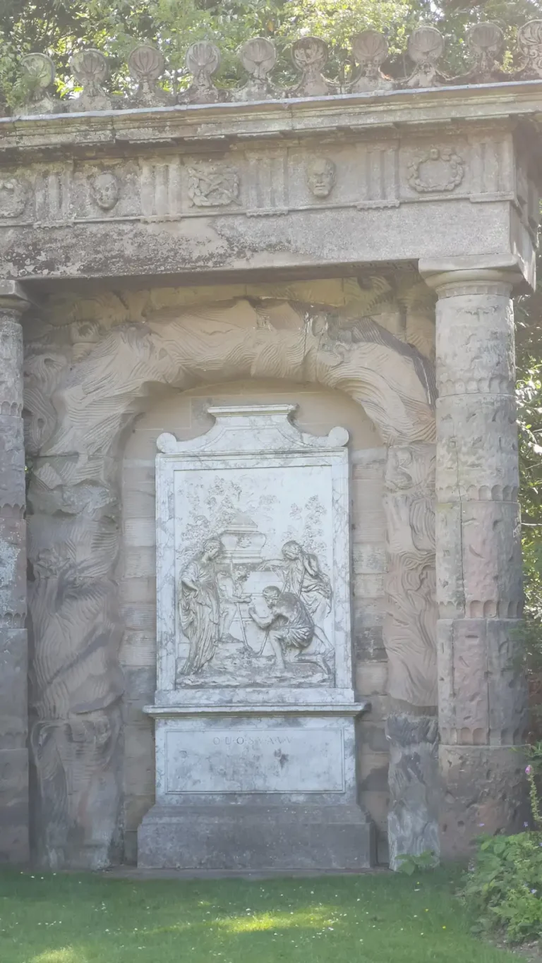 Shepherd’s Monument at Shugborough Estate, showing the ‘Dedicavit’ inscription panel with classical relief.