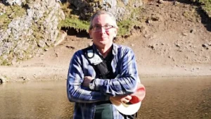 The author of the blog standing on the banks of the River Dove next to Ilam Hall,