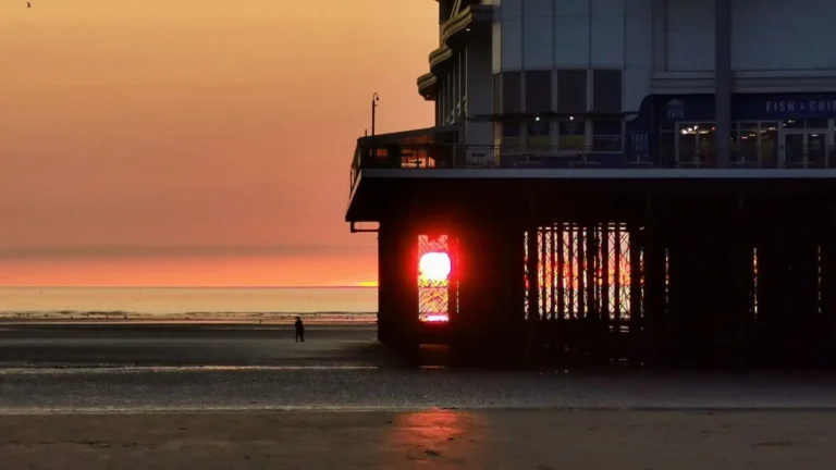 The setting sun framed perfectly between the supporting structure of the pier in Weston‑super‑Mare.