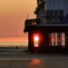 The setting sun framed perfectly between the supporting structure of the pier in Weston‑super‑Mare.