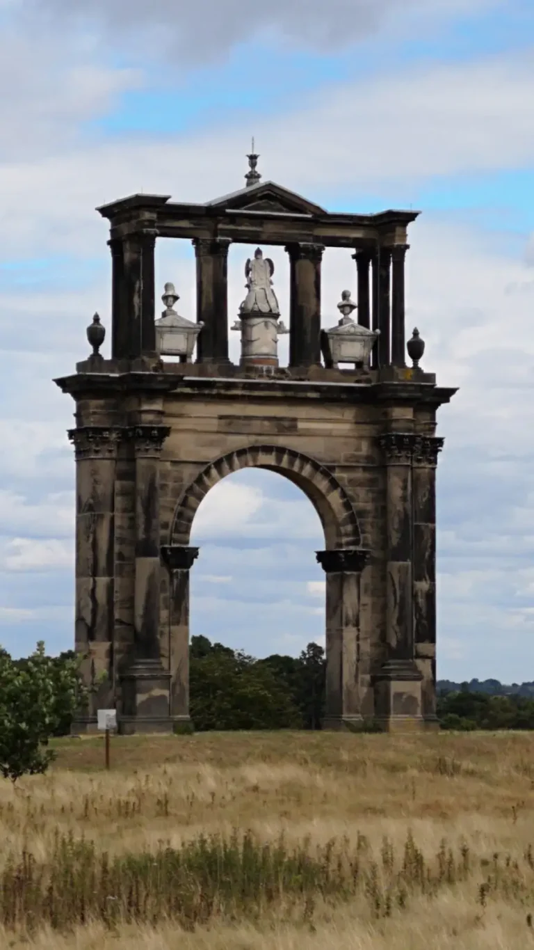 Hadrian’s Arch at Shugborough Estate, a classical eighteenth‑century triumphal arch set on open parkland.
